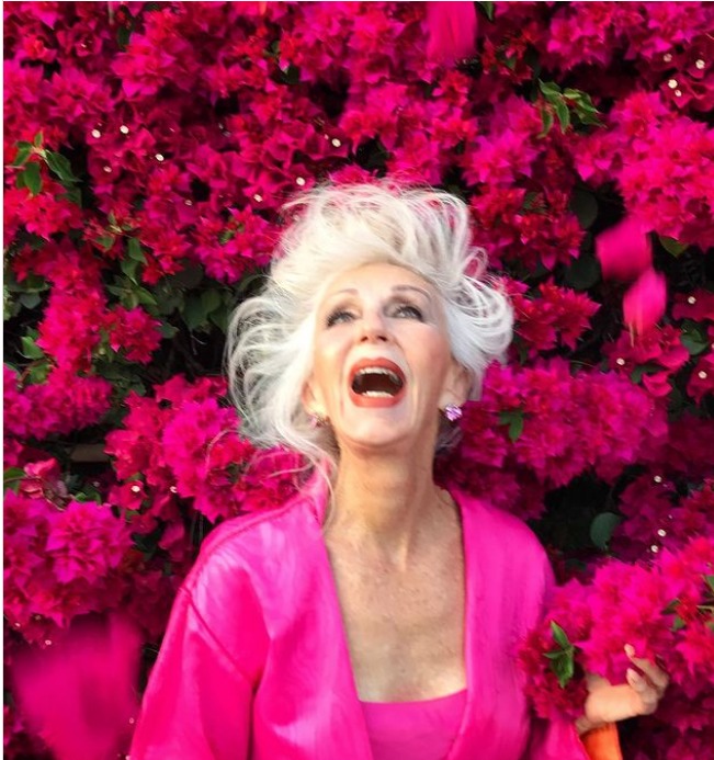 A 73-year-old gray-haired woman who has been criticized for not being age-appropriate poses in a swimsuit in response to criticism