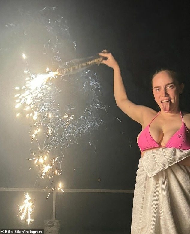 Billie Eilish puts on a very busty display in a RARE bikini snap as she lights off fireworks during the 4th of July celebration